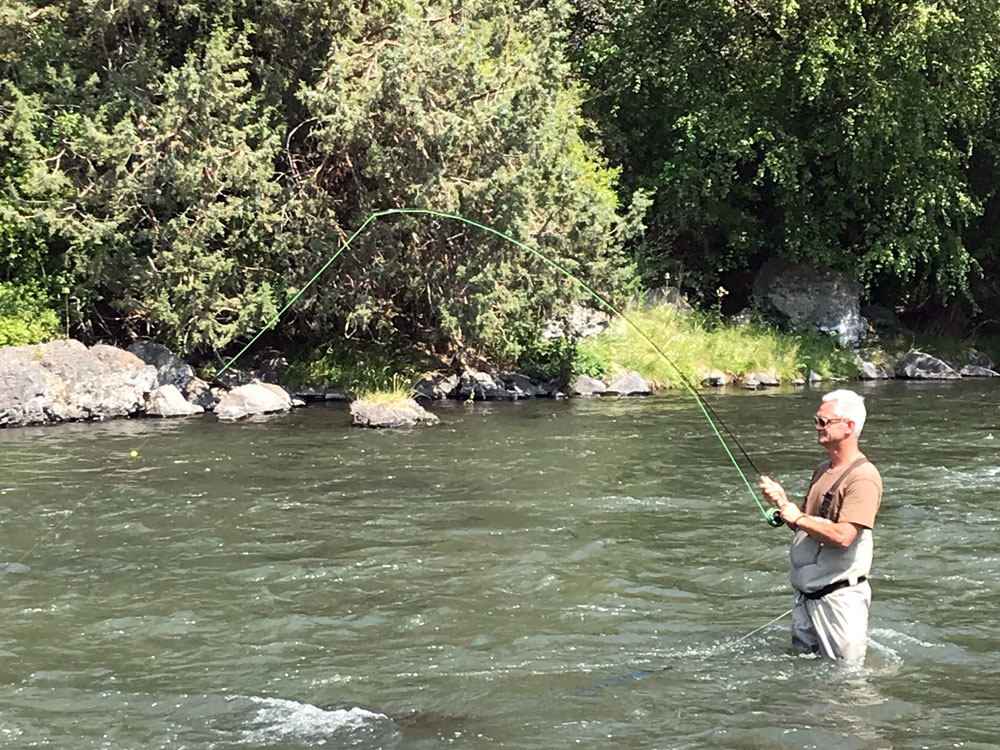 A client with a fish on the Crooked River.